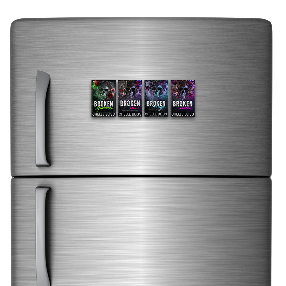refrigerator with four skull magnets on it
