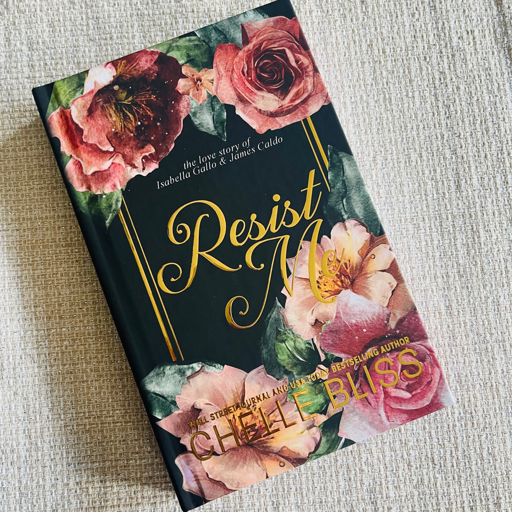 Hardcover book titled 'Resist Me' with floral design on a textured surface