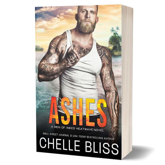 Ashes paperback book Tattooed Man with facial hair wearing a tank top on the beach