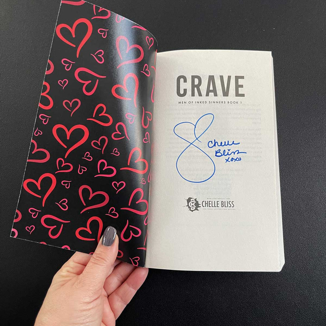Crave title page with autograph from Chelle Bliss, open cover shows red hearts on a black background.