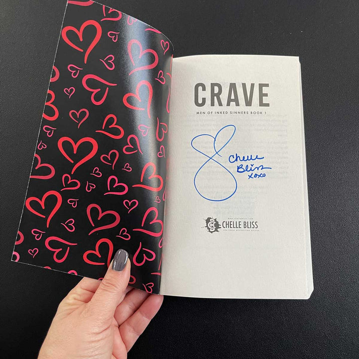 Crave title page with autograph from Chelle Bliss, open cover shows red hearts on a black background.