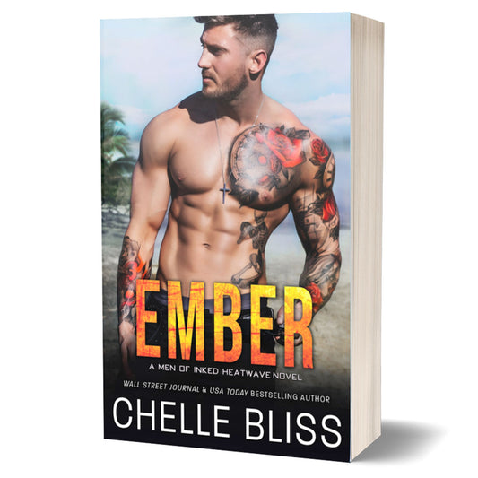 ember paperback book shirtless tattooed man at beach