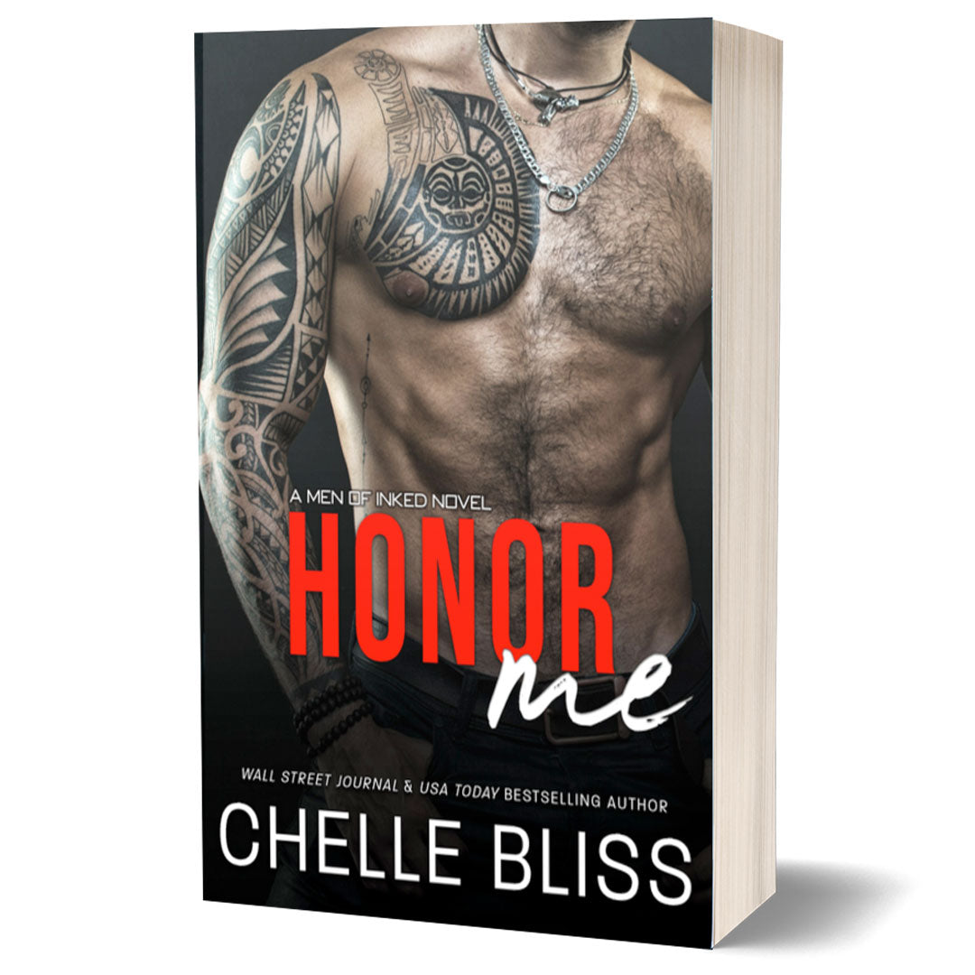 This image features the cover of the paperback book "HONOR ME" by Chelle Bliss, which is part of the Men of Inked series. The cover showcases a muscular male figure with a tattooed torso and a necklace of a skull.