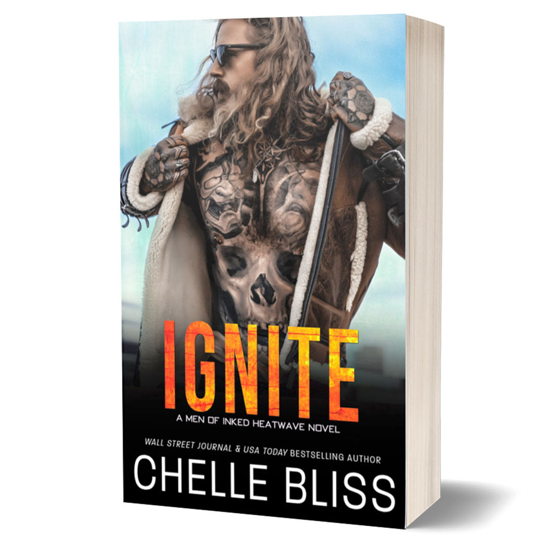 Ignite paperback book Tattooed Man in a leather fur lined jacket wearing sunglasses